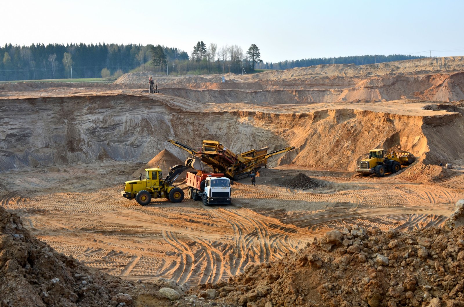 Mining operation with heavy excavation equipment and mining trucks